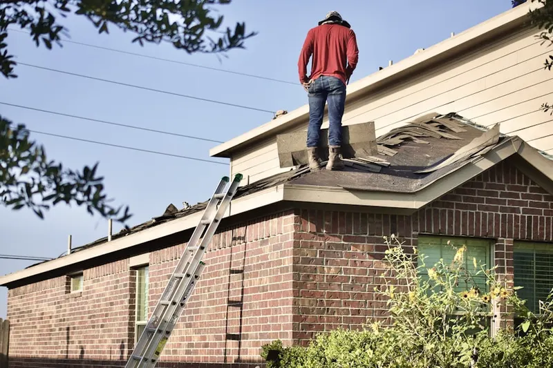Professional roofer working on a residential roof in Austins Colony